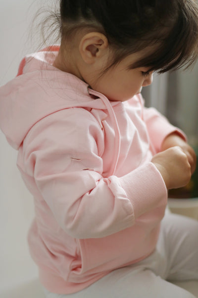 Woman in 'Love Pink' hoodie carries child wearing pink cagoule in Edinburgh  Scotland Stock Photo - Alamy